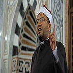 The imam pointing with his finger